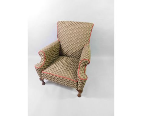 An Edwardian mahogany armchair upholstered in brown scale fabric, raised on cabriole legs.