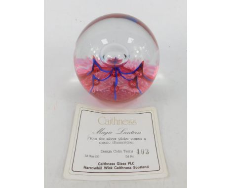 A Caithness glass paperweight, decorated in the Magic Lantern pattern, limited edition 403/750, with certificate. 