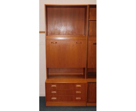 A G-Plan 1960's teak lounge unit, with a shelf over a drinks cabinet, above three long drawers, on a plinth base, 81cm x 46cm