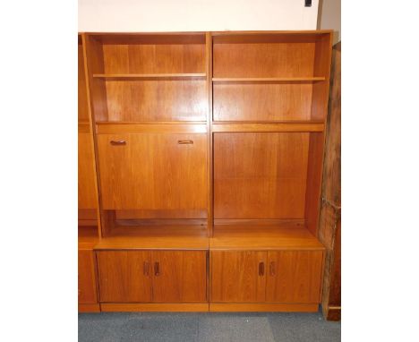 A G-Plan 1960's teak lounge unit, two part, with an open shelf, drinks cabinet, glazed two door display cabinet enclosing a s