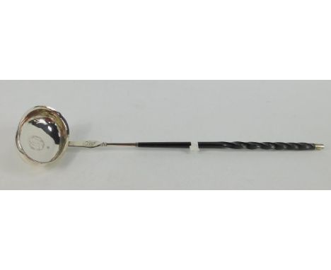 A George III toddy ladle, inset a silver coin and monogram engraved, with a whalebone handle, 38cm long. 