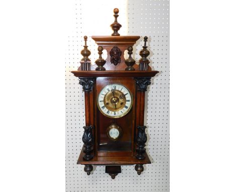 A late 19thC oak and ebonised wall clock, brass dial with enamel chapter ring bearing Roman numerals, eight day movement with