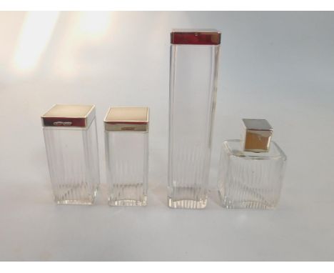 A George VI cut glass and silver lidded four piece toilet set, with engine turned decoration, comprising pin jar, two further