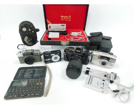 A Pentax Program A camera, with a Sigma Zoom-BII lens, Dekko cine camera, Instamatic camera and accessories.