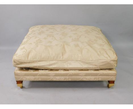A Duresta square Trafalgar stool, upholstered in ivory floral fabric, loose cushion, on tapering square legs, capped on casto