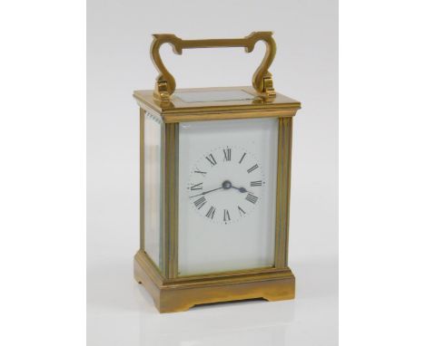 A brass carriage clock, with enamel dial bearing Roman numerals, single barrel movement, with key, 8 x 6 x 14.5cm.