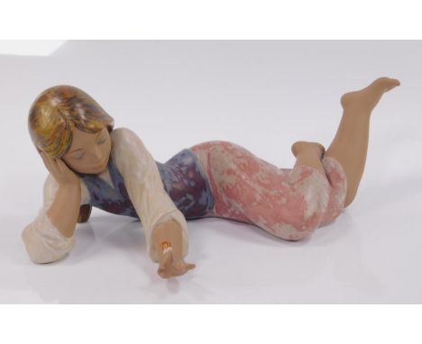 A Lladro matt porcelain figure of a girl lying down with a snail on her finger, printed mark, 34cm long.