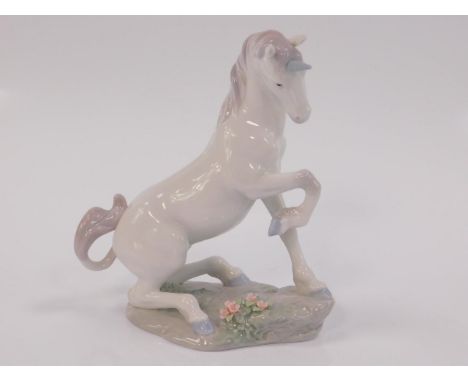 A Lladro porcelain figure of a unicorn, modelled resting on its haunch with right front leg raised, Privilege piece 2002, pri