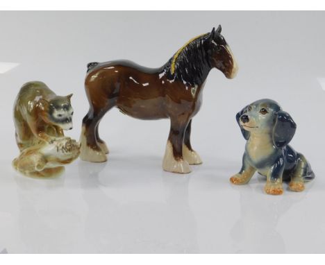 A Beswick pottery figure of a brown gloss shire horse, Sylvac seated puppy and a Gerold porcelain figure of a racoon, (3).