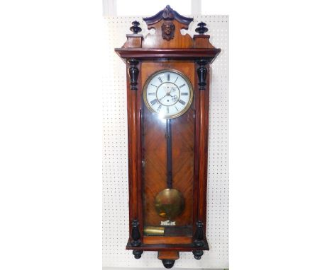 A late 19thC Vienna wall clock, walnut cased, circular enamel dial bearing Roman numerals, subsidiary seconds dial, thirty ho