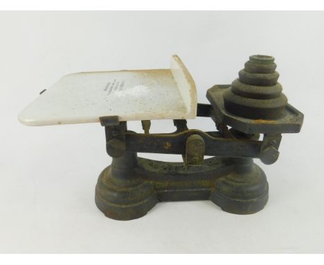 A set of H. Webb cast iron and ceramic kitchen scales, with weights. 
