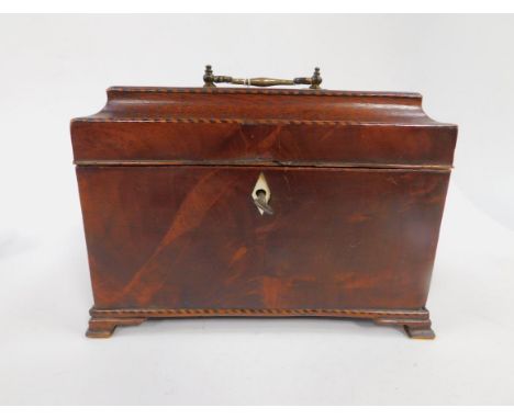 A George III mahogany boxwood and ebonised banded tea caddy, with brass carry handle, lead lined single compartment, raised o