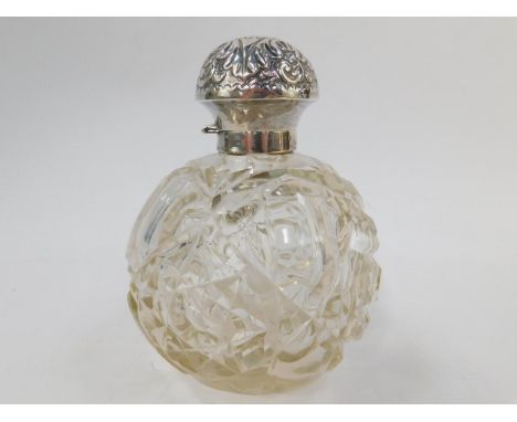 A George V cut glass scent bottle, with a silver mount and hinged lid, with engine turned decoration. 