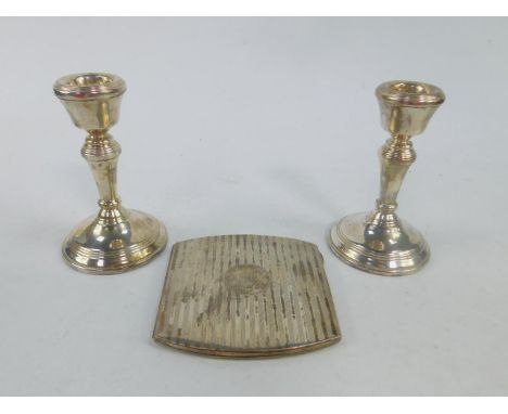 A pair of Elizabeth II silver loaded candlesticks, Birmingham 1995, and a George V silver cigarette case, with engine turned 