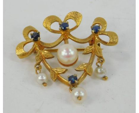 A 9ct sapphire and cultured pearl brooch, of bow, leaf and berry form, 4.5g.