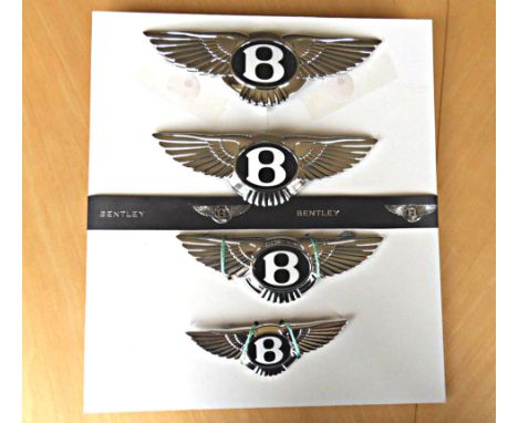 Four Bentley modern winged car badges, widths tip to tip: 7.50in, 7in, 6.25in and 4.9in, the two largest have rubber backings
