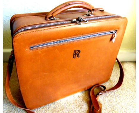 Rolls-Royce Motors leather case, in tan hide lined with R-R Country Check, prominient RR insignia to the front, zip pull engr