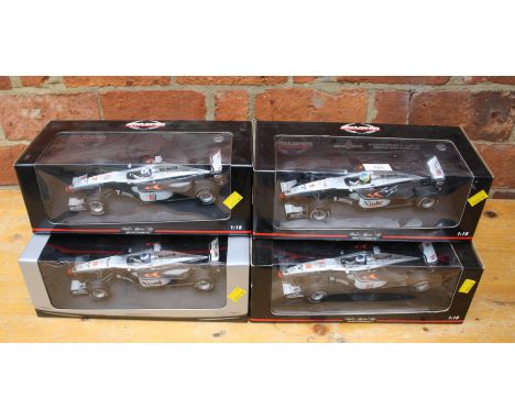 A collection of four Minichamps 1:18 scale model cars, similar to lot 46