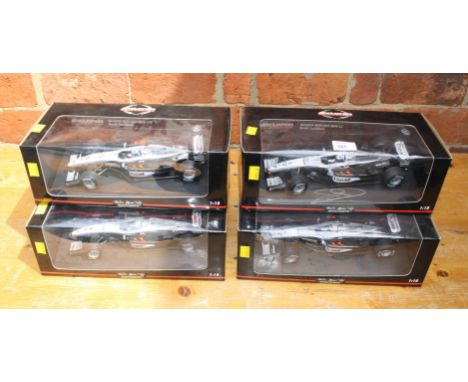 A collection of four Minichamps 1:18 scale, ltd edition McClaren Mercesdes F1 class, one signed by David Coultard
