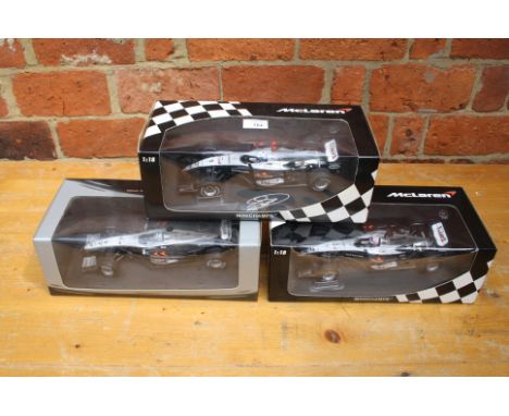 A collection of three Minichamps 1:18 scale ltd edition McClaren Mercedes F1 cars one signed by David Coultard