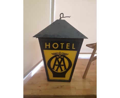 A vintage black japanned hanging illuminated AA Hotel sign, with yellow and black transluscent panels (panels replaced c1960)