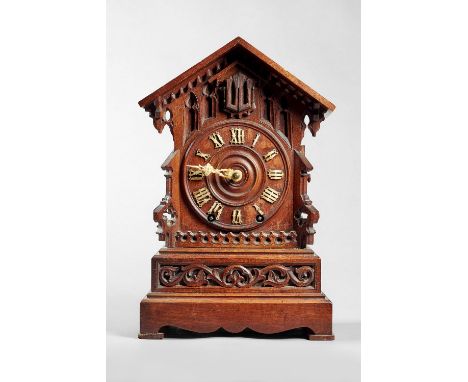 A Tyrolean walnut fusée cuckoo clock Circa 1890The case in the form of a chalet with arched pediment and deep overhang, denti