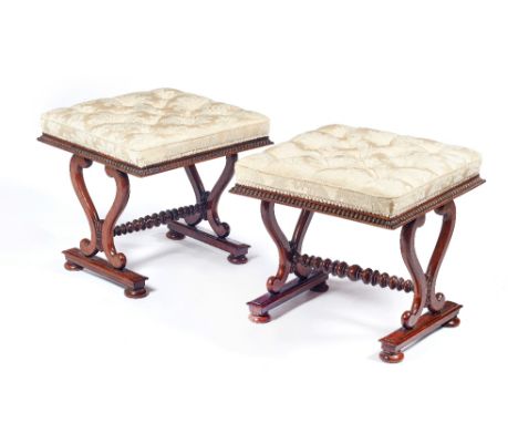 Attributed to William Trotter; a near pair of Regency rosewood framed footstools, each with over stuffed rectangular top on l