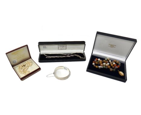 A single row necklace of uniform cultured pearls, on a snap clasp, detailed 925, a single row necklace of vary coloured hards