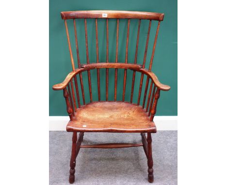 A late George III beech and elm comb back Windsor chair, with solid seat and turned supports, 70cm wide x 116cm high x 48cm d