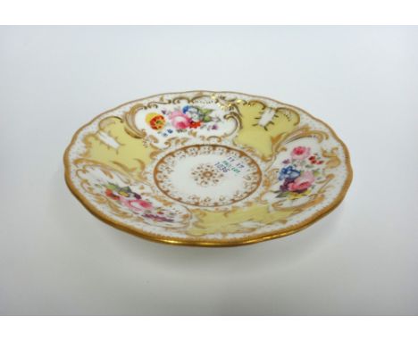 A Minton porcelain part tea service, circa 1830, gilt foliate decorated against a yellow ground, comprising; two twin handled