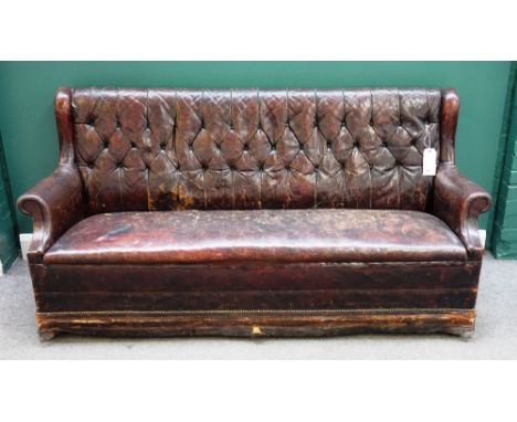 A brass studded tan leather upholstered club sofa, with roll over arms and block feet 190cm wide x 93cm high x 69cm deep.