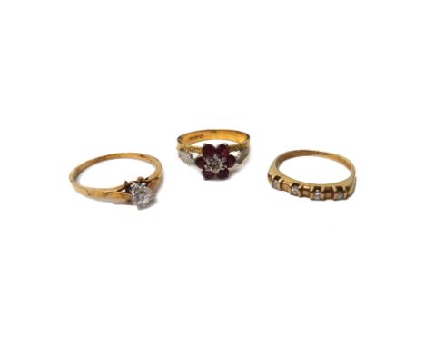 An 18ct gold, ruby and diamond set seven stone cluster ring, with bark textured decoration to the shoulders, a 9ct gold and d