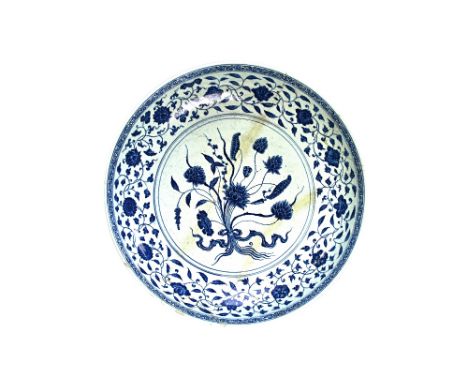A large Chinese blue and white dish in Ming style, probably 18th century,  painted in the centre with a tied lotus bouquet, b