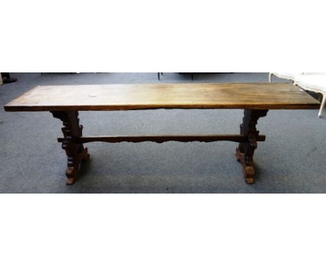 A 17th century and later Italian walnut console table, the single plank rectangular top on a pair of shaped trestle end suppo