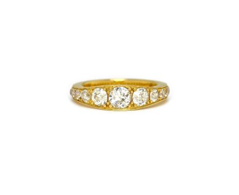 An 18ct gold and diamond ring, mounted with a row of seventeen cushion shaped diamonds graduating in size to the centre stone