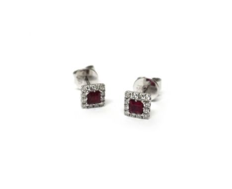 A pair of 18ct white gold, ruby and diamond set square cluster earstuds, each mounted with a square ruby to the centre within