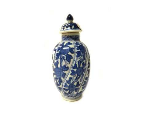 A small Chinese blue and white spiral moulded ovoid vase and a cover, Kangxi, painted with panels of fruiting branches,(a.f),