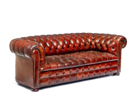 A brown leather upholstered Chesterfield sofa, with brass studded decoration, 220cm wide x 75cm high x 90cm deep.  Illustrate