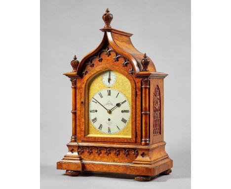 A late Victorian walnut Gothic Revival three train mantel clockBy Dent, London, No. 41210, circa 1890The arched case with thr