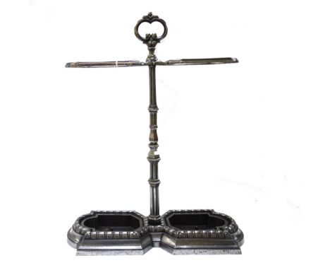 An Edwardian style polished steel twin division stick stand, with foliate loop handle over a tapering hexagonal shaft, with t