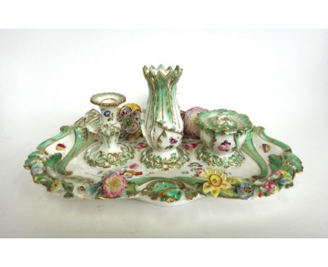 An English porcelain desk set, 19th century, with loop handle and a shaped, floral encrusted tray, with inkwell, night light 