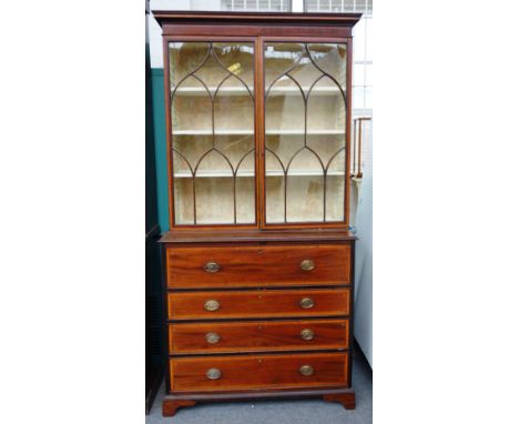 A George III satinwood banded mahogany secretaire cabinet, the pair of astragal glazed doors over a fitted drawer and three f