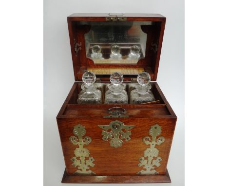 A Victorian brass mounted oak decanter/games compendium box with lift top and fall front, enclosing a fitted interior, 36cm w