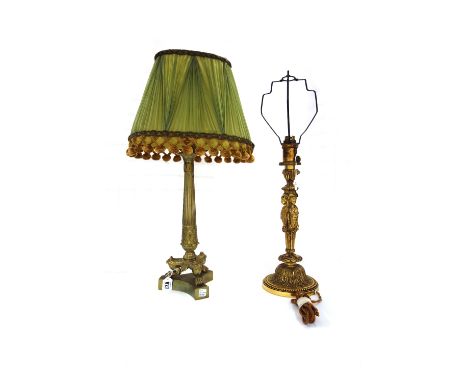 A French ormolu table lamp, 19th century, with a tapering fluted column over three lion paw feet and a triform base, with a p