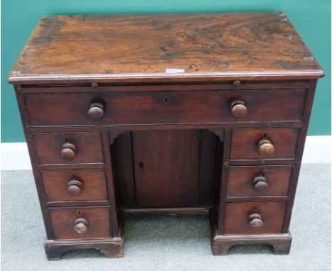 A mid-18th century mahogany kneehole writing desk, with seven drawers about the cupboard, on bracket feet, 91cm wide x 77cm h