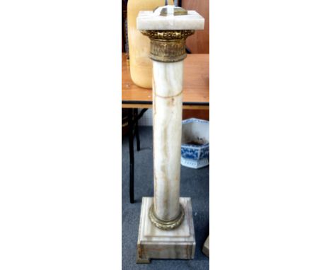 An onyx pedestal, late 19th century, with foliate cast ormolu mounts, square top, tapering circular column and a stepped squa