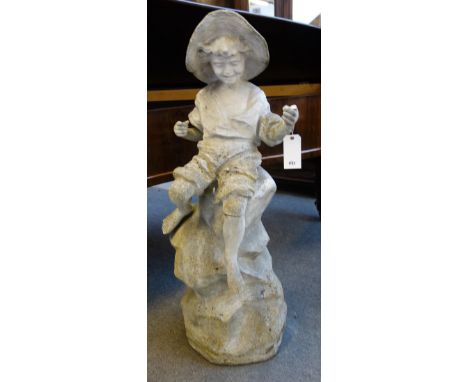 After Goldscheider, a reconstituted stone statue of a young fisher boy, wearing a wide brim hat, sat on rocks, 45cm wide x 13