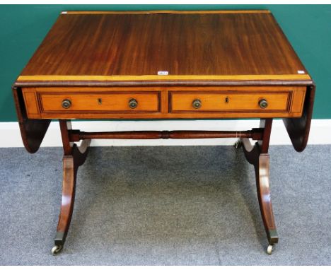 A Regency satinwood banded mahogany sofa table, with pair of frieze drawers and dummy opposing, on four downswept supports, 9