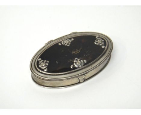 An 18th century silver mounted oval hinge lidded snuff box, gilt within, the tortoiseshell lid decorated with a wirework bird