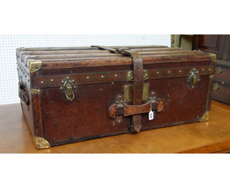 A French 'Moynat' leather and brass bound travel trunk, early 20th century with wooden slats to the lid and base, twin leathe